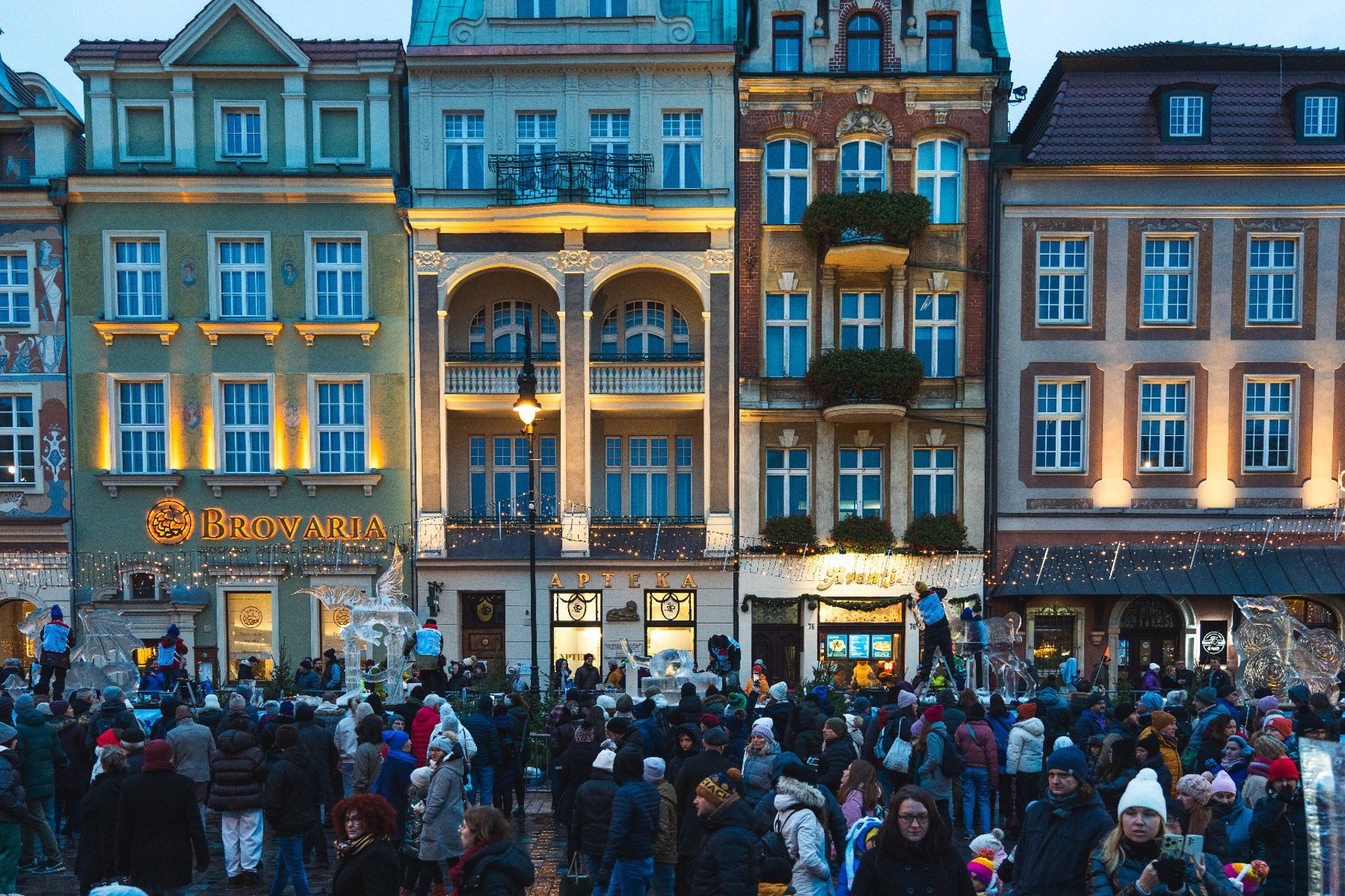 people pose for a photo against the backdrop of ice