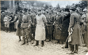 Piłsudski odbierajacy defiladę w towarzystwie oficerów i urzędników.