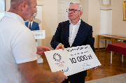 Prezydent Poznania wręcza czek Szymonowi Ziółkowskiemu